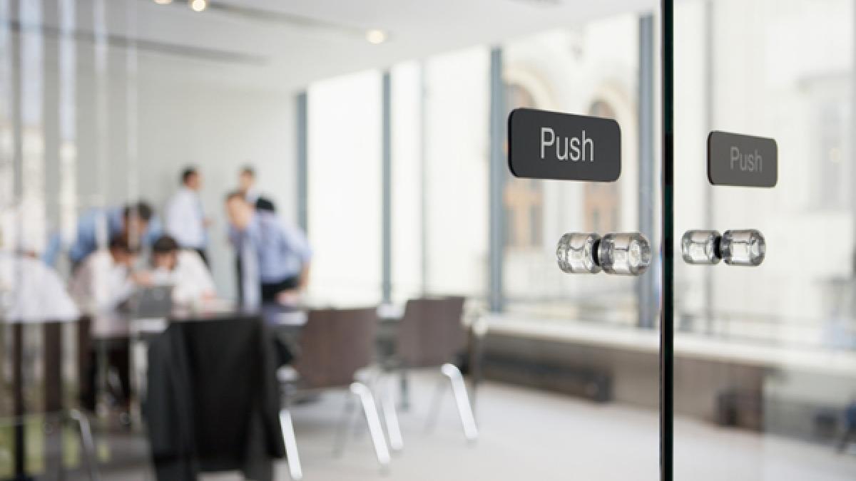 Office meeting behind glass doors